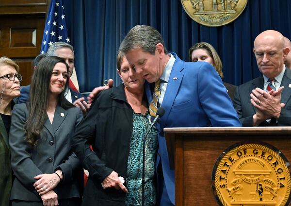 Gov. Brian Kemp comforts Deborah Rider, who lost her son in a drive-by shooting, during a press conference to introduce anti-gang bills at the Georgia State Capitol building in Atlanta on Thursday, January 30, 2020. (Hyosub Shin / Hyosub.Shin@ajc.com)