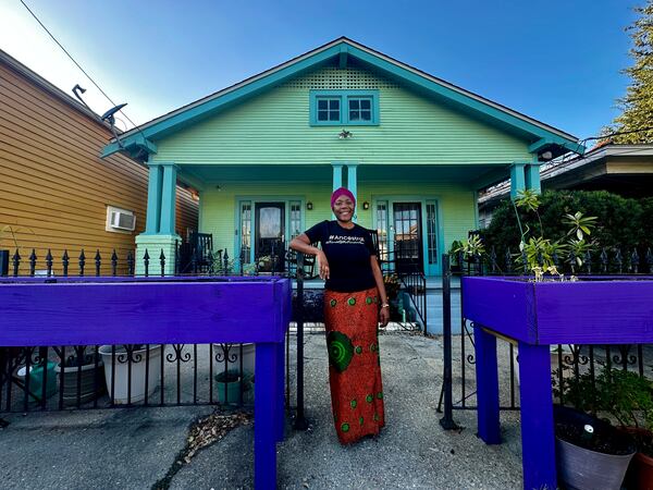 Candice Henderson-Chandler poses in front of her home, also known as the Freedom House, where Civil Rights leaders in New Orleans once used as a safe house, Oct. 23 2024. (AP Photo/Stephen Smith)