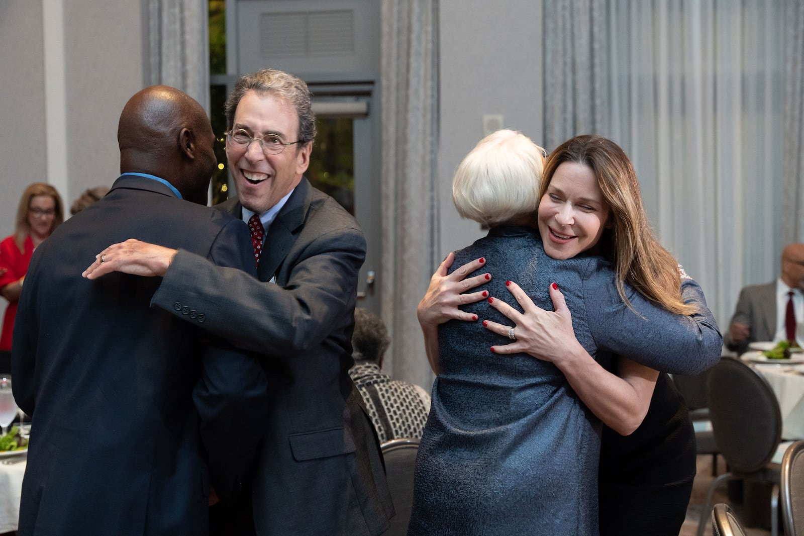 Clark Howard and his wife Lane hugging friends at the Atlanta Press Club Hall of Fame ceremony which inducted Howard on Oct. 28, 2024. Krys Alex