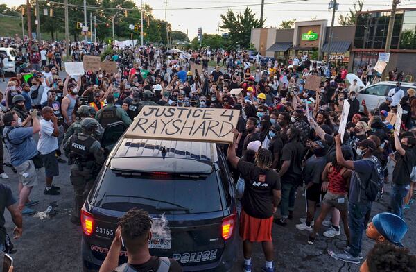 Police deploy tear gas at a Saturday demonstration after the shooting death of Rayshard Brooks in Atlanta.    Ben Gray for the Atlanta Journal Constitution