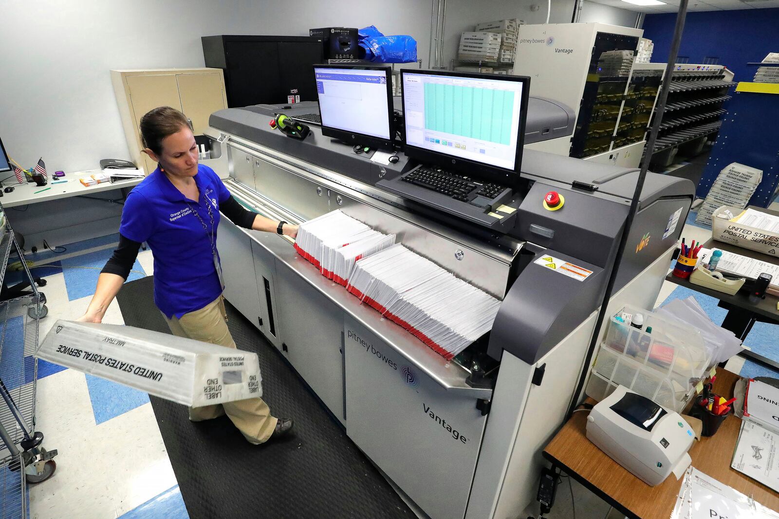 FILE - A worker processes mail-in ballots for the state's primary elections at the Orange County Supervisor of Elections office in Orlando, Fla., March 17, 2020. (Joe Burbank/Orlando Sentinel via AP, File)