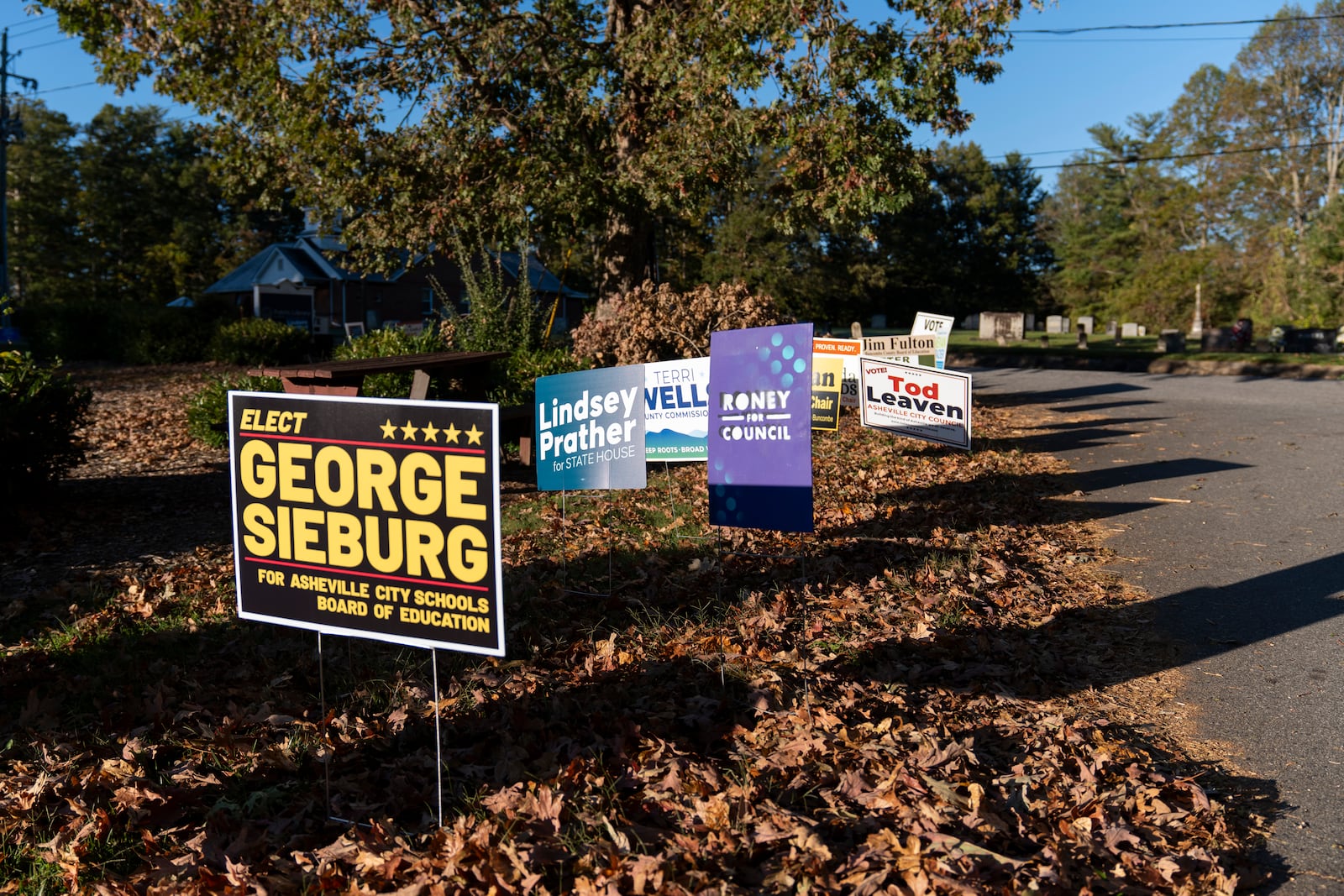 Campaign signs are seen at the polling place at Skyland/South Buncombe Library in Asheville, N.C. during the first day of early in-person voting, on Oct. 17, 2024. (AP Photo/Stephanie Scarbrough)