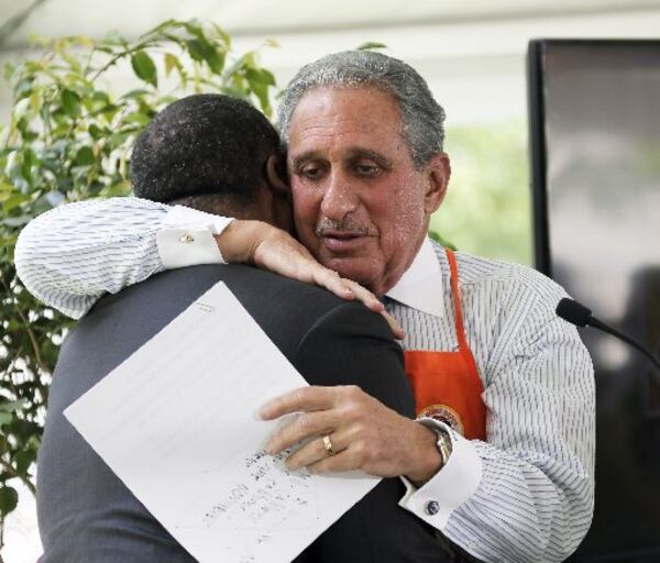 Atlanta Falcons owner Arthur Blank hugs Kasim Reed after the Atlanta mayor gave him a warm introduction at the Friday press conference announcing Home Depot Backyard.