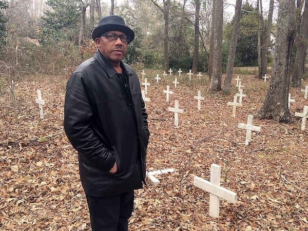 Waymond Mundy in an African American cemetery in Monroe where Mae Murray Dorsey, one of the Moore’s Ford lynching victims, is buried. Many of the graves were unmarked and marred by development when Mundy and others in the Moore’s Ford Memorial Committee marked the graves with white crosses. The group helped install a headstone to recognize Dorsey.