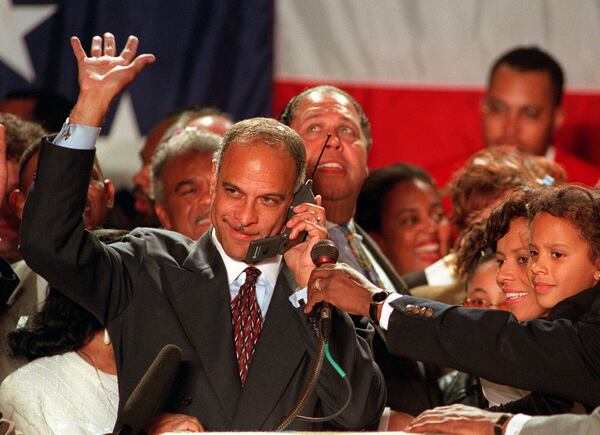 Surrounded by his family and political supporters, Mayor Bill Campbell waves to the crowd as he accepts a congratulatory phone call from President Bill Clinton on Tuesday, Oct. 25, 1997. (AJC)