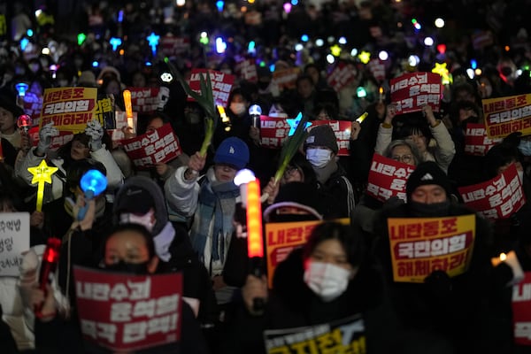 Participants gather to stage a rally demanding South Korean President Yoon Suk Yeol's impeachment, in front of the headquarters of the ruling People Power Party in Seoul, South Korea, Tuesday, Dec. 10, 2024. The banners read "Immediately impeachment Yoon Suk Yeol." (AP Photo/Lee Jin-man)