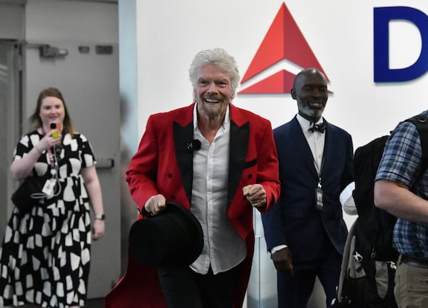 Richard Branson, founder of the Virgin Group, makes a surprise appearance as Virgin Voyages and Delta host a full departure gate takeover prior to the flight's boarding at Hartsfield-Jackson Atlanta International Airport, Thursday, Feb. 29, 2024, in Atlanta. Sir Richard Branson, Delta Air Lines and Virgin Voyages surprised customers on Delta Flight 1946 (from ATL to SJU), gifting all an-board a free cruise to celebrate all-new itineraries and the brand’s growing presence in San Juan later this year. (Hyosub Shin / Hyosub.Shin@ajc.com)