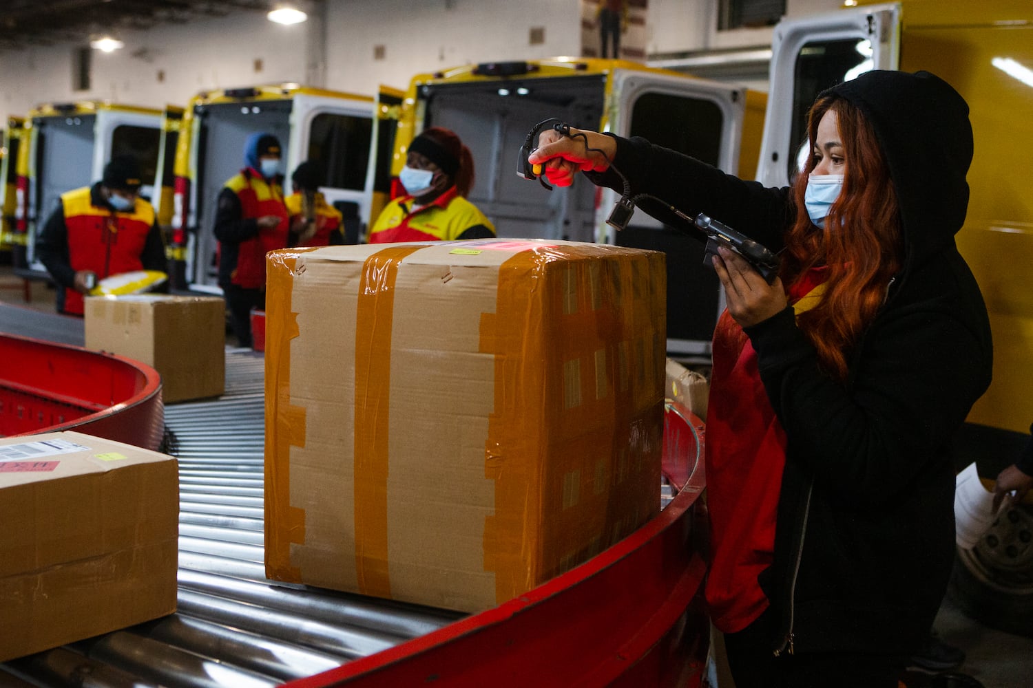 Mahogany Clark scans packages on Wednesday, December 16, 2020, at DHL Express in Atlanta. Workers at the shipping center worked to fulfill orders during the holiday rush. CHRISTINA MATACOTTA FOR THE ATLANTA JOURNAL-CONSTITUTION.