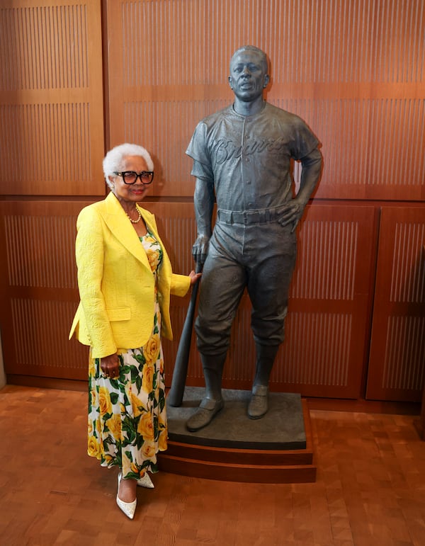 Billye Aaron, Hank Aaron’s widow, stands next to the Hank Aaron statue by the grand staircase at the National Baseball Hall of Fame, Thursday, May 23, 2024, in Cooperstown, NY. (Jason Getz / AJC)
