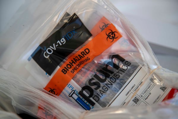 COVID-19 test kits sit ready for use during a DeKalb County Department of Health drive-through testing site in Doraville on Nov. 17, 2020.  (Atlanta Journal-Constitution)