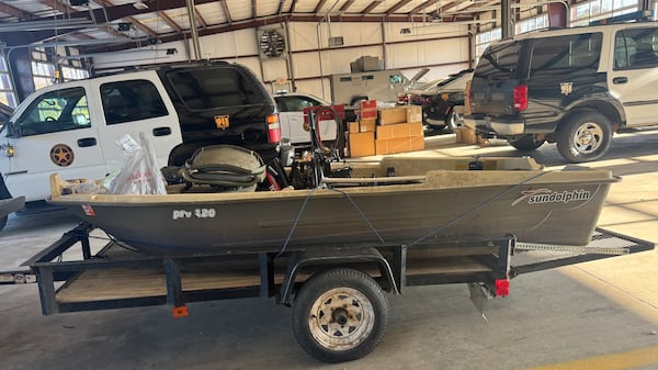 The 11-foot fishing boat that belongs to Gary Jones, the Westminster Schools teacher and coach, who went missing Feb. 8 while on a Lake Oconee boating trip with his fiancee, Joycelyn Wilson. The boat, pictured here in the Putnam County sheriff's vehicle shelter on Feb. 20, is shown after its engine was removed from its mount for transport from the lake. Items on the bow were placed there after it was stored and the picture is not of the boat in the state it was found on Feb. 8 while floating with no one aboard. (Joe Kovac Jr. / AJC)