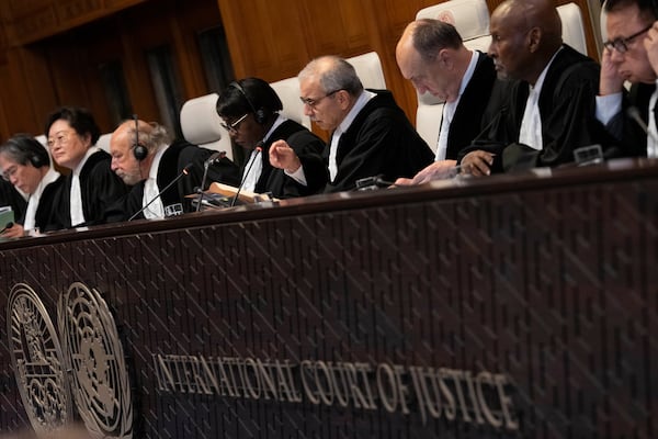 Presiding Judge Nawaf Salam, gestures as the International Court of Justice in The Hague, Netherlands, opens hearings into what countries worldwide are legally required to do to combat climate change and help vulnerable nations fight its devastating impact, Monday, Dec. 2, 2024. (AP Photo/Peter Dejong)