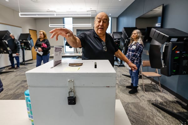 A man casts his ballot during early voting in Waukesha, Wis., Tuesday, March 18, 2025. (AP Photo/Jeffrey Phelps)