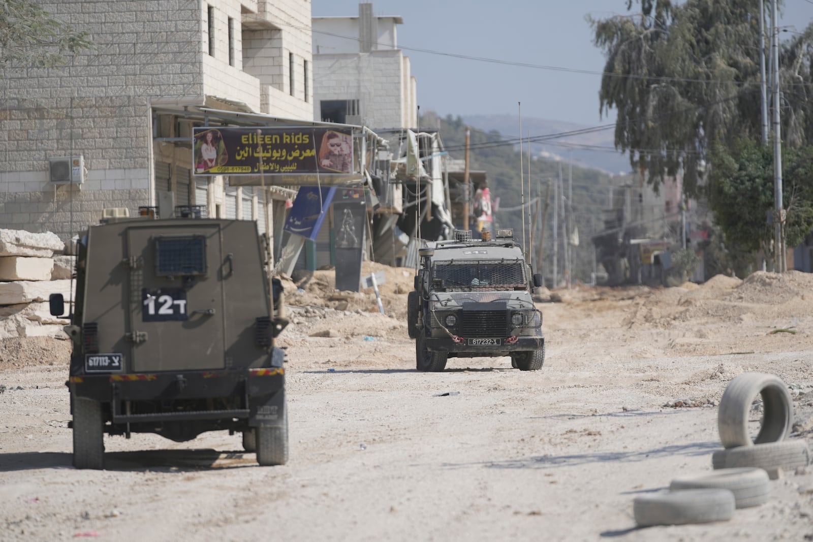 Israeli army units secure the parameter of the Nur Shams refugee camp during the ongoing army operation, after the Palestinian Health Ministry said two Palestinians were killed in an Israeli strike and a third by Israeli gunfire, in the West Bank city of Tulkarem Thursday, Oct. 31, 2024. (AP Photo/Nasser Nasser)