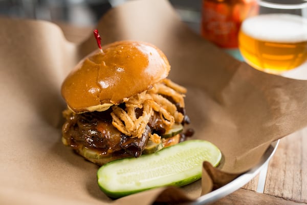  The Bucky Goldstein with slow-roased Wagyu beef brisket, sliced sour pickle, onion rings, Dijon mustard. Photo credit- Mia Yakel