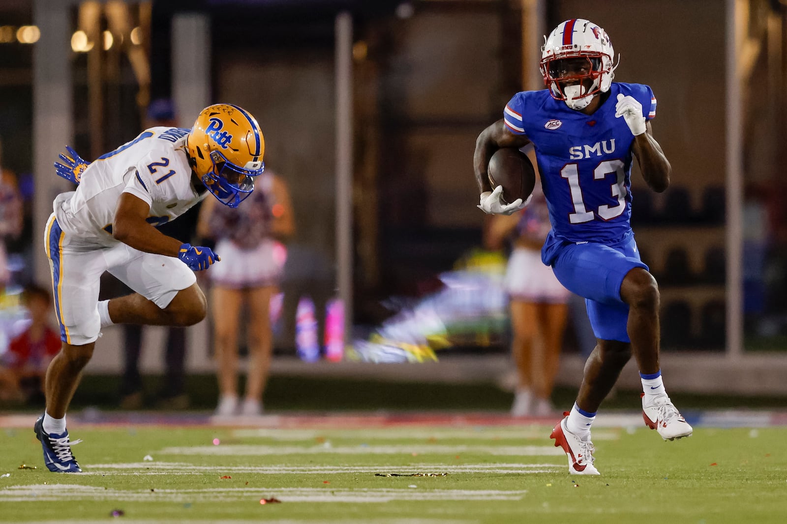 SMU wide receiver Roderick Daniels Jr. (13) returns an onside kick past Pittsburgh wide receiver Che Nwabuko (21) during the second half of an NCAA college football game in Dallas, Saturday, Nov. 2, 2024. (AP Photo/Gareth Patterson)