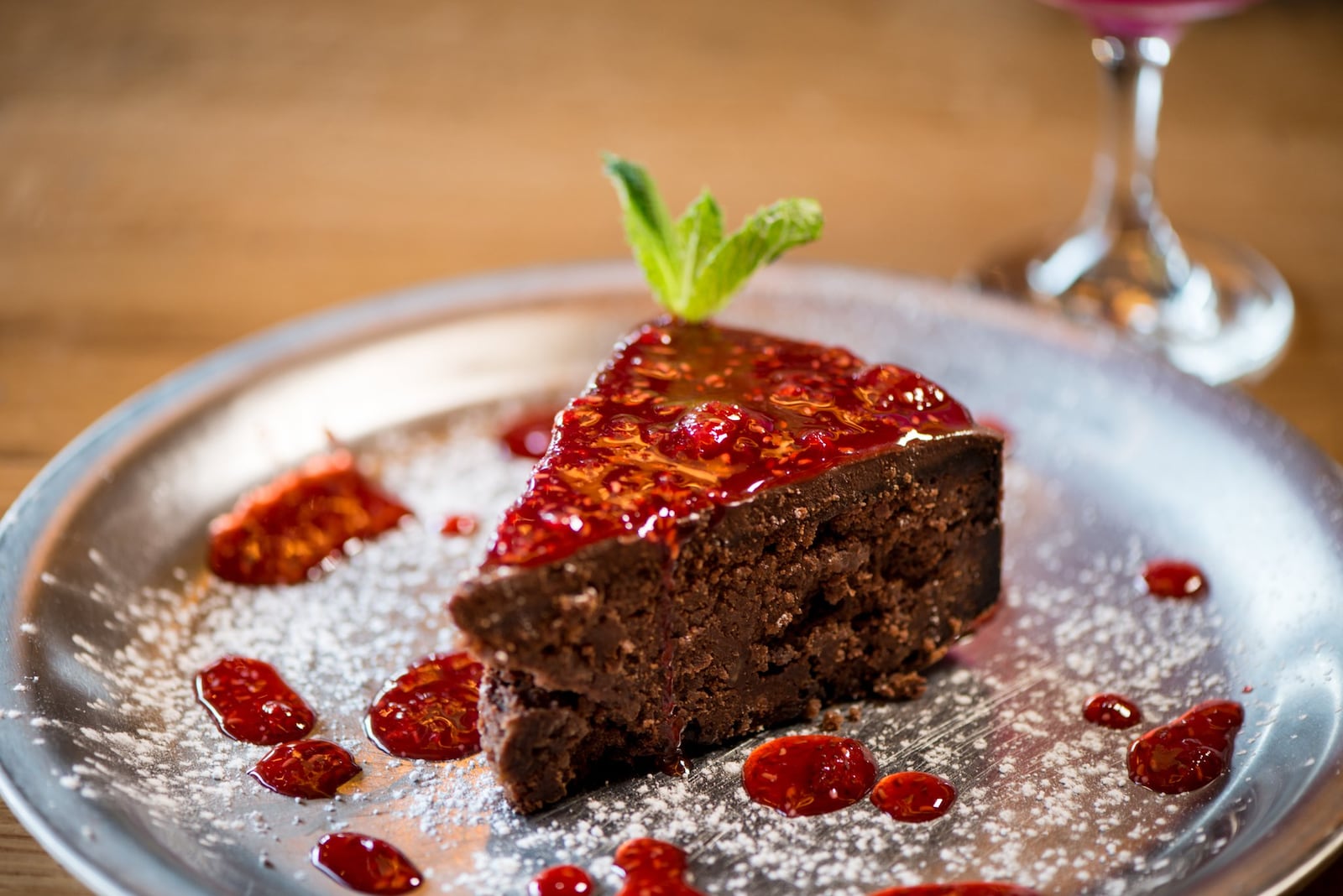 Ammazza Decatur Torta Caprese, flourless chocolate almond cake topped with chocolate ganache and berry compote. Photo credit- Mia Yakel.