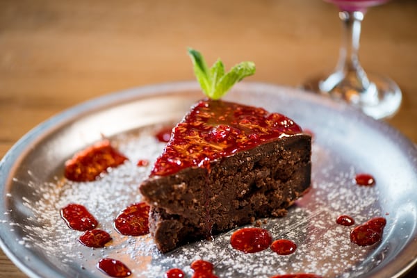 Ammazza Decatur Torta Caprese, flourless chocolate almond cake topped with chocolate ganache and berry compote. Photo credit- Mia Yakel.