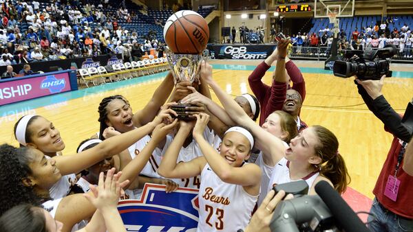  Holy Innocents Golden Bears hoist the Class AA girls championship trophy in 2016. (AJC)