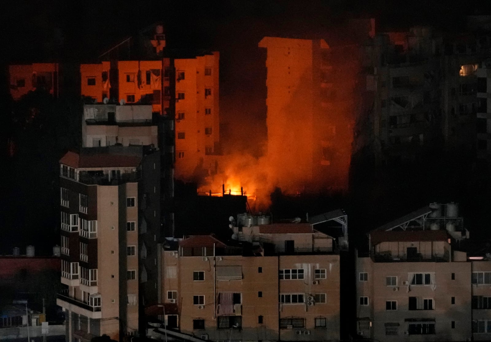 Flame rise from a past Israeli airstrike on Dahiyeh, in the southern suburb of Beirut, Lebanon, early Friday, Oct. 25, 2024. (AP Photo/Hussein Malla)