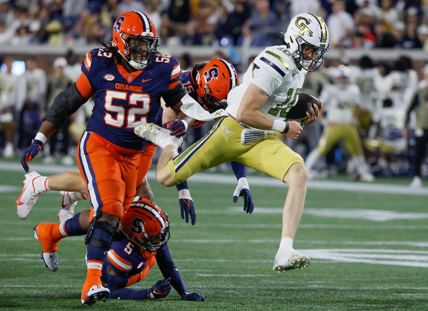 Georgia Tech Yellow Jackets quarterback Haynes King (10) makes a first down on a keeper during the first half of an NCAA college football game between Georgia Tech and Syracuse in Atlanta on Saturday, Nov. 18, 2023.   (Bob Andres for the Atlanta Journal Constitution)