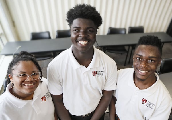 Flanked by two of his teammates, Jordan Thomas took home the debate championship of the annual residency hosted by the Harvard Debate Council. Payton Gunner (at left) and class president Osazi Al Khaliq (at right) make up part of the 25-person Atlanta team, who call themselves “The Great Debaters.”“I was determined to represent my city and my story. I wanted people to see where I came from and how I could keep up with them,” Thomas said. (AJC Staff/Bob Andres)