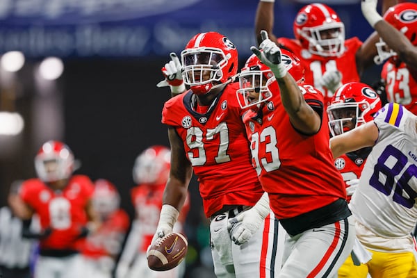 Georgia Bulldogs defensive tackle Warren Brinson (97) and defensive end Tyrion Ingram-Dawkins (93) celebrate after Brinson recovered a fumble by LSU Tigers quarterback Garrett Nussmeier (not pictured) during the fourth quarter of the SEC Championship game at Mercedes-Benz Stadium, Saturday, December 3, 2022, in Atlanta. Georgia won 50-30. (Jason Getz / Jason.Getz@ajc.com)
