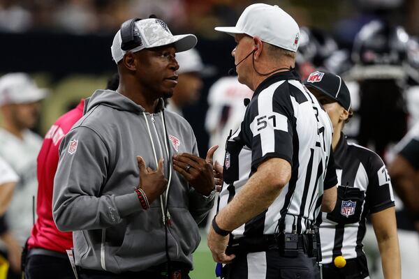 Atlanta Falcons head coach Raheem Morris speaks with referee Carl Cheffers (51) during the second half of an NFL football game against the New Orleans Saints, Sunday, Nov. 10, 2024, in New Orleans. (AP Photo/Butch Dill)