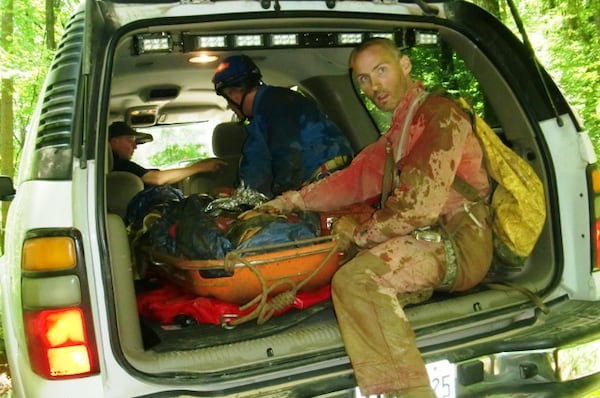 Rescue volunteer Andy Voss accompanies an injured hiker who has been evacuated from Ellison's Cave. CONTRIBUTED: BUDDY LANE