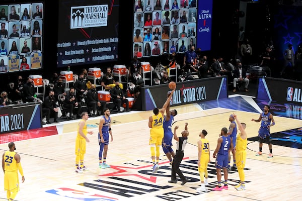 Team LeBron forward Giannis Antetokounmpo (34) of the Milwaukee Bucks and Team Durant forward Zion Williamson of the New Orleans Pelicans jump to tip off the NBA All-Star game Sunday, March 7, 2021, at State Farm Arena in Atlanta. (Curtis Compton/ccompton@ajc.com)