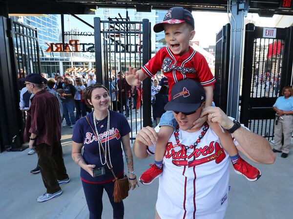 March 31, 2017, Atlanta: Excited Braves fans David Swinehamer, his son Austin, 4, and wife Amber enter the gates for the first time for the MLB exhibition game against the N.Y. Yankees for the soft opening of SunTrust Park on Friday, March 31, 2017, in Atlanta.   Curtis Compton/ccompton@ajc.com