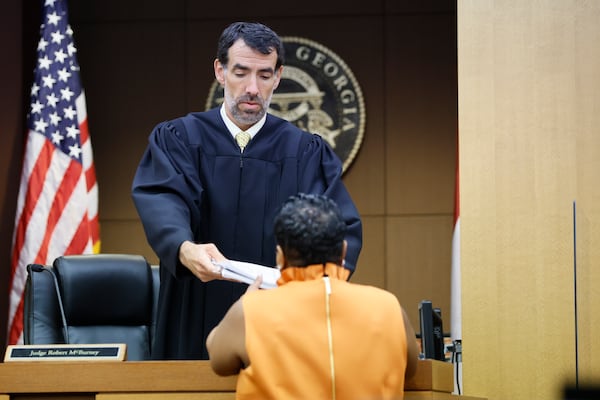 After hours of grand jury testimony Monday, Aug. 14, 2023, Fulton County Clerk Ché Alexander received a copy of the indictment from Judge Robert McBurney. The clerk said the indictment results would be made public in three hours or fewer. (Miguel Martinez / miguel.martinezjimenez@ajc.com)