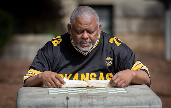 Amos King sits and reads his bible on a bench near the Decatur Square on March 11, 2021.  STEVE SCHAEFER FOR THE ATLANTA JOURNAL-CONSTITUTION