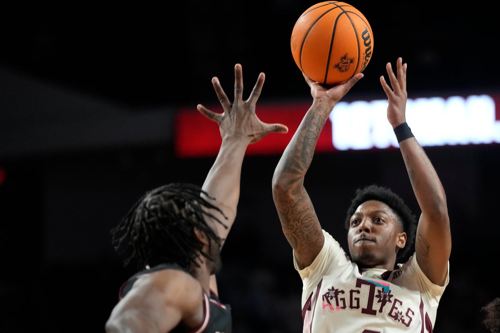 FILE - Texas A&M guard Wade Taylor IV (4) shoots over South Carolina forward Collin Murray-Boyles (30) during the first half of an NCAA college basketball game Wednesday, Feb. 28, 2024, in College Station, Texas. (AP Photo/Sam Craft, File)