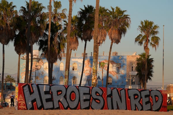 A mural by Sergei Statsenko, who also goes by the artist name Steeke, thanks firefighters in the Venice Beach area of Los Angeles as wildfires burn Monday, Jan. 13, 2025. (AP Photo/Damian Dovarganes)