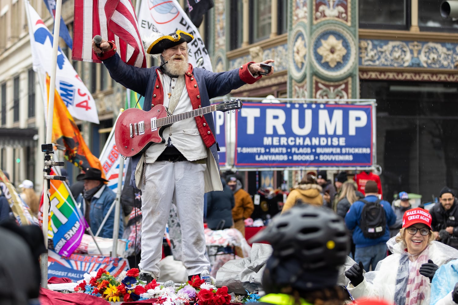 A performer entertains people waiting to enter a Trump rally at Capital One Arena in Washington, D.C. on Sunday, January 19, 2025, one day before Donald Trump’s inauguration. (Arvin Temkar / AJC)