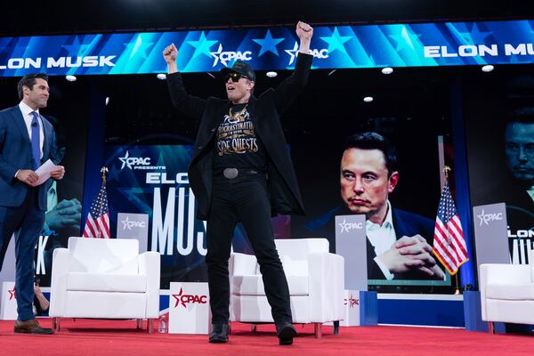 Elon Musk, right, arrives to speak at the Conservative Political Action Conference, CPAC, at the Gaylord National Resort & Convention Center, Thursday, Feb. 20, 2025, in Oxon Hill, Md. (AP Photo/Jose Luis Magana)