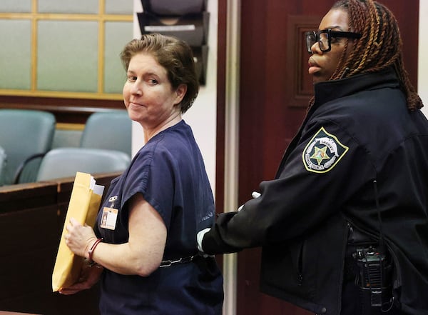 Sarah Boone smiles as she is led off in handcuffs in a courtroom of the Orange County Courthouse in Orlando, Florida, on Monday, Dec. 2, 2024. (Stephen M. Dowell/Orlando Sentinel via AP)