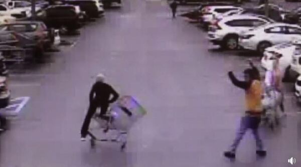 Video released by the police department shows the shopper pushing his cart at a suspect who was running away from officers.