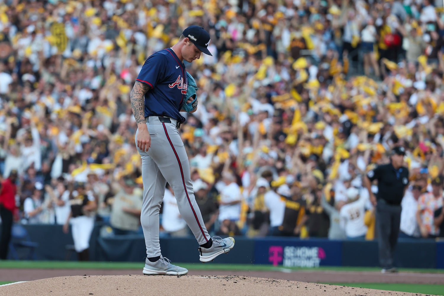 Atlanta Braves pitcher AJ Smith-Shawver (32) grooms the pitching mound after a 2-RBI home run to San Diego Padres’ Fernando Tatis Jr. during the first inning of National League Division Series Wild Card Game One at Petco Park in San Diego on Tuesday, Oct. 1, 2024.   (Jason Getz / Jason.Getz@ajc.com)