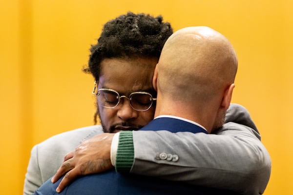 Shannon Stillwell (left) hugs his attorney Max Schardt after Schardt’s closing arguments in the YSL trial at Fulton County Courthouse in Atlanta on Monday, November 25, 2024. (Arvin Temkar / AJC)