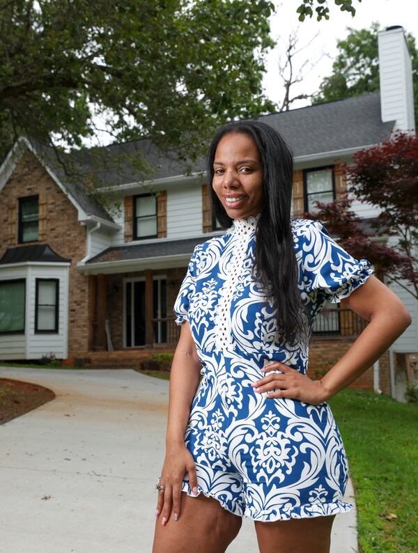 Juanita Ramos poses for a portrait in front of her home, Thursday, May 11, 2023, in Douglasville, Ga. Ramos joins a number of single women buying homes, as single women far outpace men in house buying. A generation ago, it would have been unusual for a single woman to own a home, but Juanita decided not to be intimidated by the worry about finances and repairs. (Jason Getz / Jason.Getz@ajc.com)