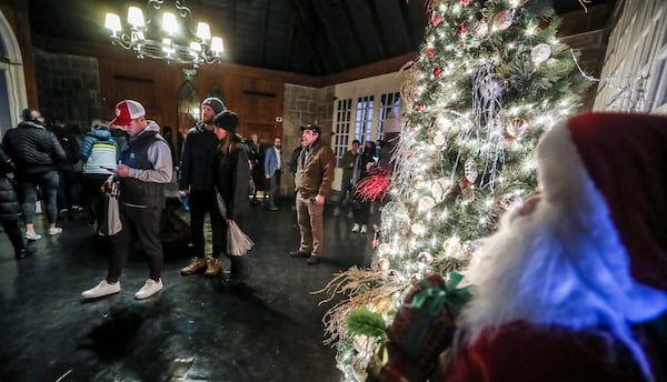 Voters line up near Christmas decorations on Dec. 6 to cast ballots in Georgia's U.S. Senate runoff between Democratic U.S. Sen. Raphael Warnock and Republican challenger Herschel Walker after neither candidate won a majority of the vote in the Nov. 8 election. Warnock won the runoff. Now, Republicans in the General Assembly could alter, or even eliminate, the runoff system. (John Spink / John.Spink@ajc.com)
