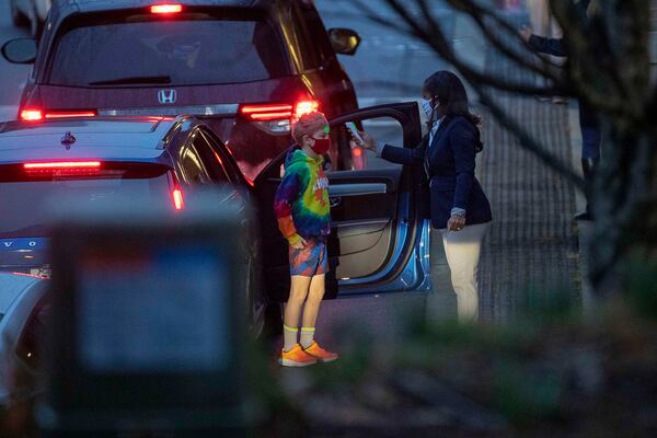 E. Rivers Elementary School students get their temperatures checked before entering the building on Jan. 25, 2021, the first day Atlanta classrooms reopened after closing because of the COVID-19 pandemic in March 2020. (Alyssa Pointer/AJC FILE PHOTO)