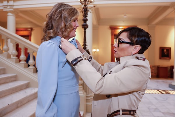 State Rep. Inga Willis(right) adjusts the bow of Sen. Elena Parent at the Capitol in Atlanta. Both Atlanta Democrats made the 2025 AJC best dressed list.