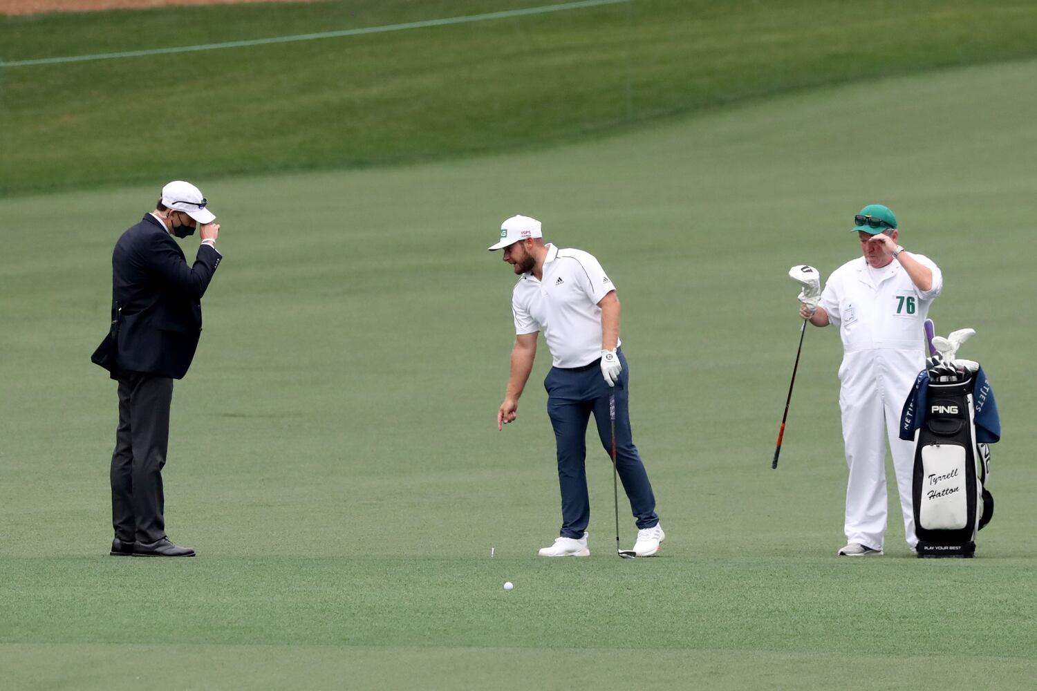 April 10, 2021, Augusta: Tyrrell Hatton gets a ruling on the second fairway after his ball landed in the crosswalk during the third round of the Masters at Augusta National Golf Club on Saturday, April 10, 2021, in Augusta. Curtis Compton/ccompton@ajc.com