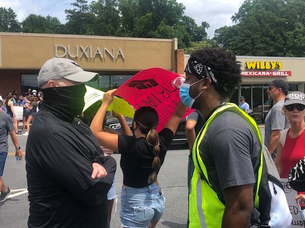 Falcons coach Dan Quinn talking with one of the organizers of the Buckhead protest, University of Virginia linebacker Nicholas Jackson. (By D. Orlando Ledbetter/dledbetter@ajc.com).