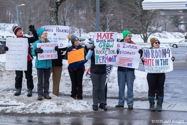 Protesters of Vice President JD Vance stand near Main Street, Rt. 100, in Waitsfield, Vt., Saturday, March 1, 2025. (Jeff Knight/The Valley Reporter via AP)