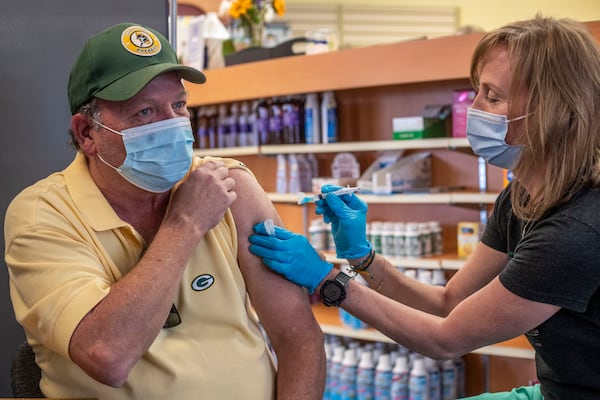 Dunwoody resident Randy Krafft receives his second Moderna COVID-19 vaccination at a pharmacy in April 2021. (Alyssa Pointer / Alyssa.Pointer@ajc.com)