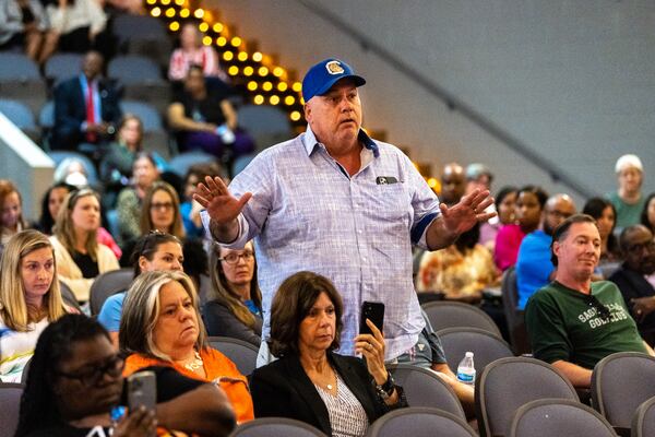 Parent J. Max Davis asks if the public can ask questions at a town hall meeting featuring DeKalb superintendent finalist Devon Horton at Chamblee High School in Chamblee on Wednesday, April 12, 2023. (Arvin Temkar / arvin.temkar@ajc.com)